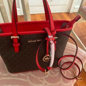 This is the Michael Kors Jet Set Travel Extra-Small Logo Top-Zip Tote Bag.